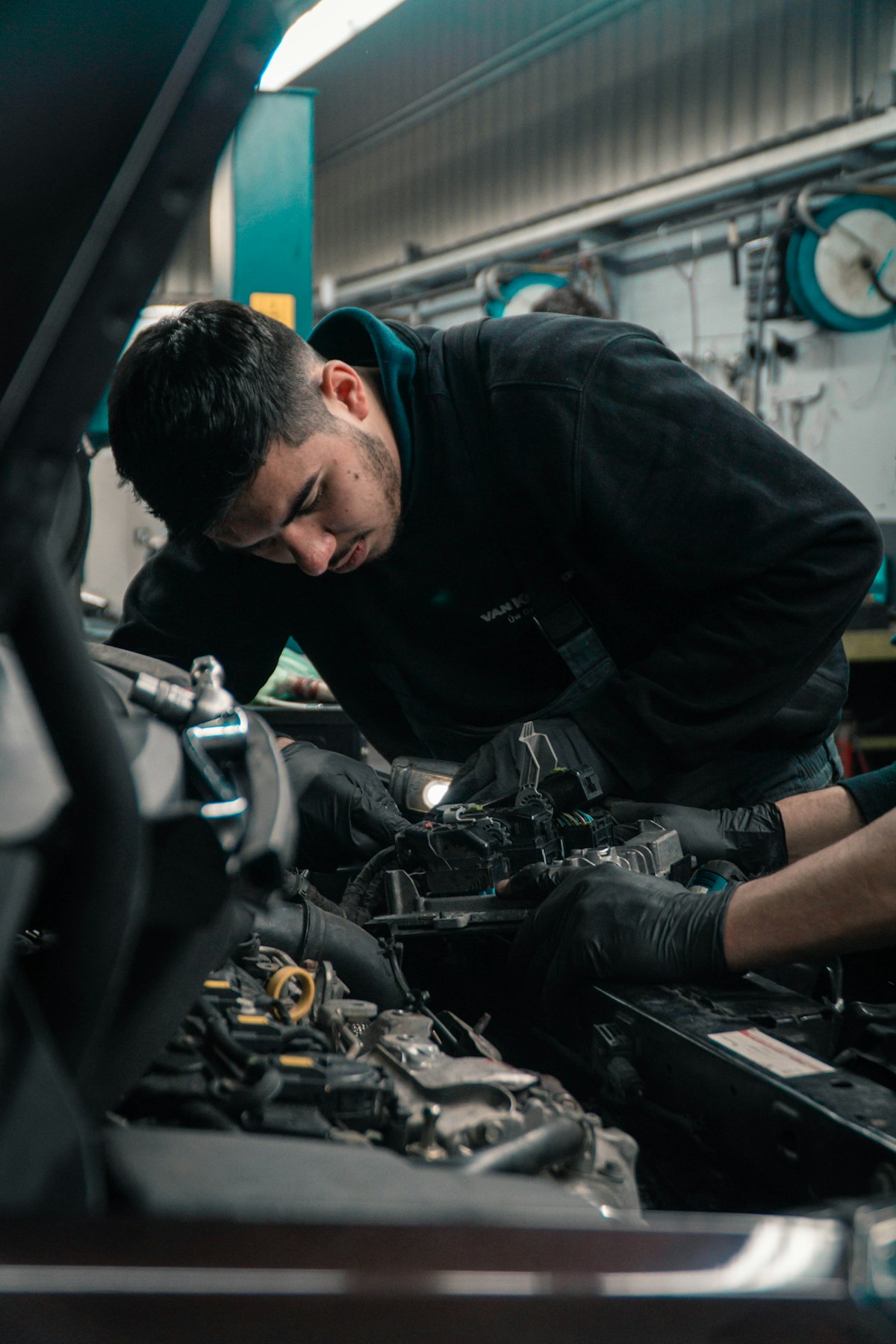 Mechanic working under the hood in our shop